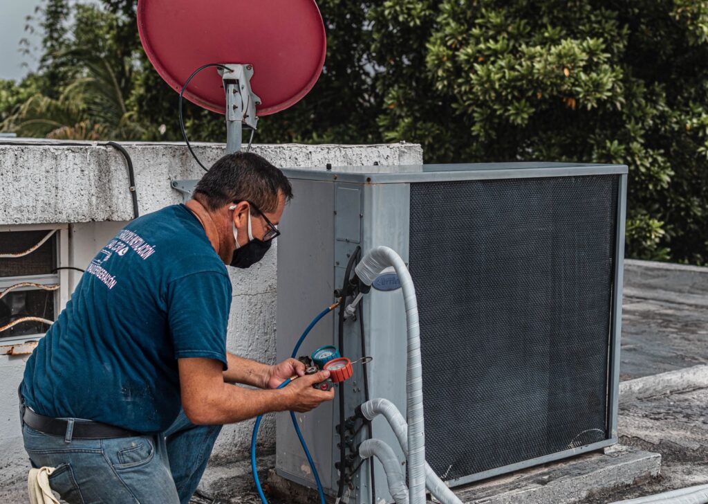 Technician repairing an air conditioner unit