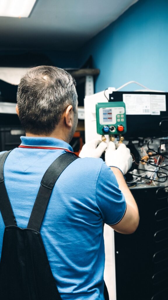 Technician servicing an air conditioning system near South Brisbane